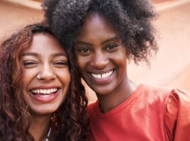 Two young woman smiling to camera