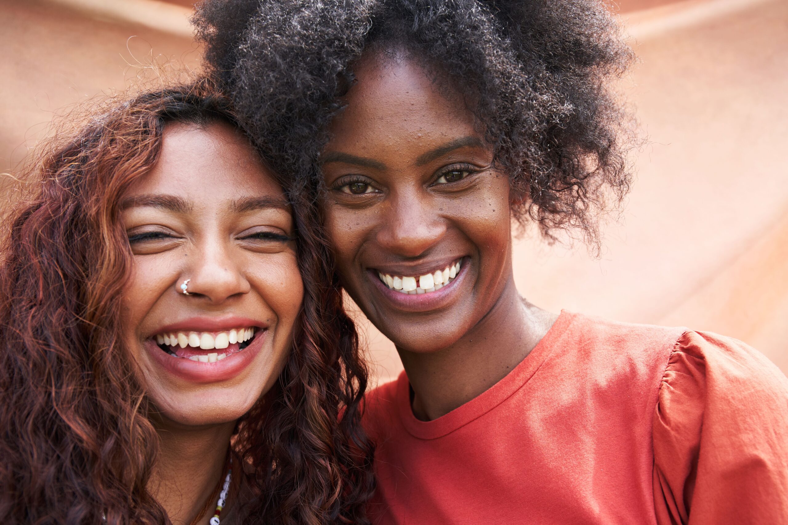 Two young woman smiling to camera